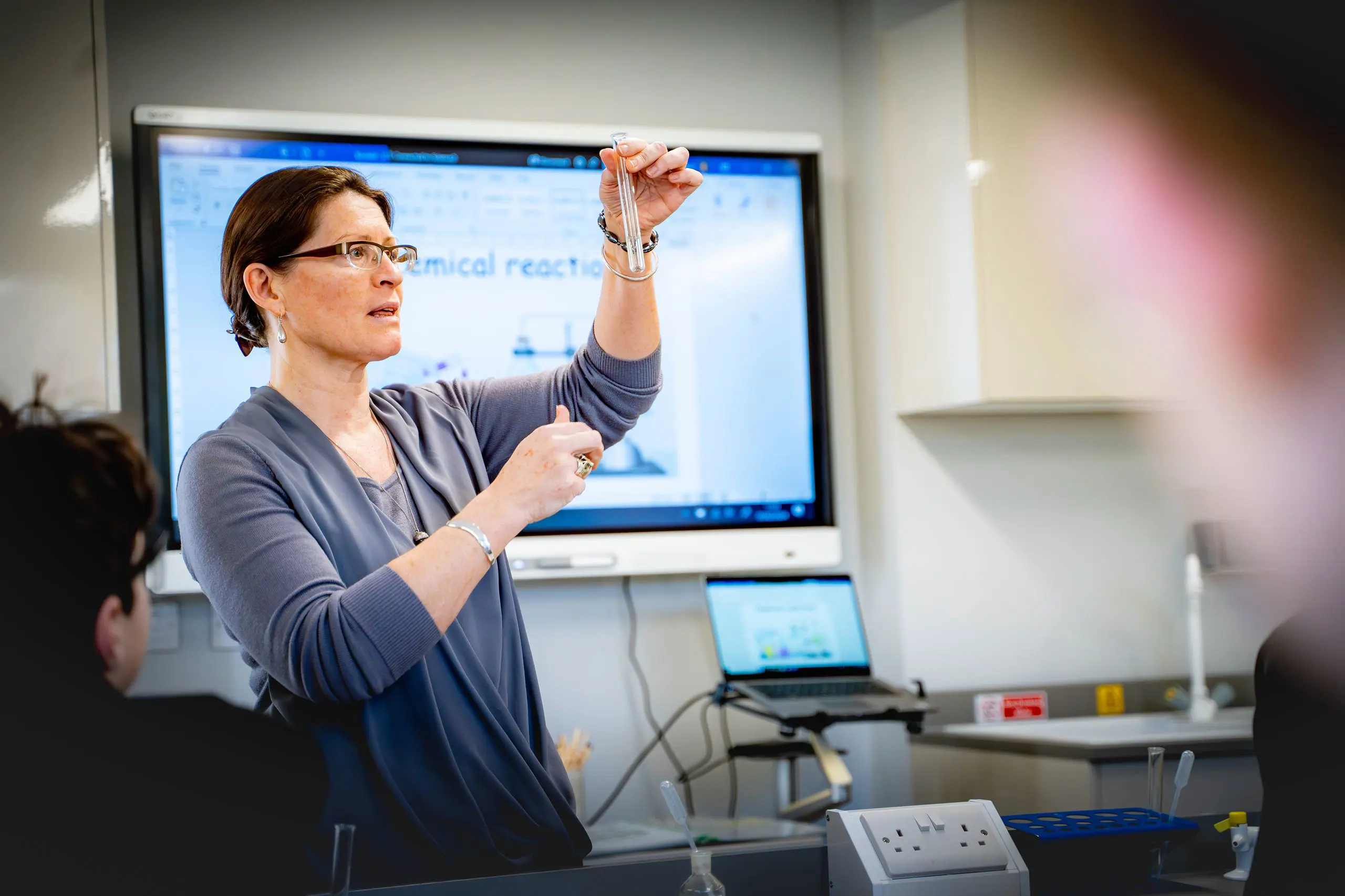 Female teacher explaining a science concept during a classroom lesson at Moon Hall School